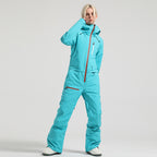 Model wearing the aqua blue Alpine Access one-piece ski suit with the front zipper closed to the collar.