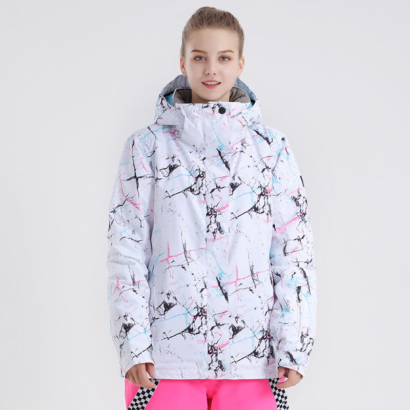 Front view of a model wearing the white Cloudline women's snow jacket with black, pink and blue abstract print.