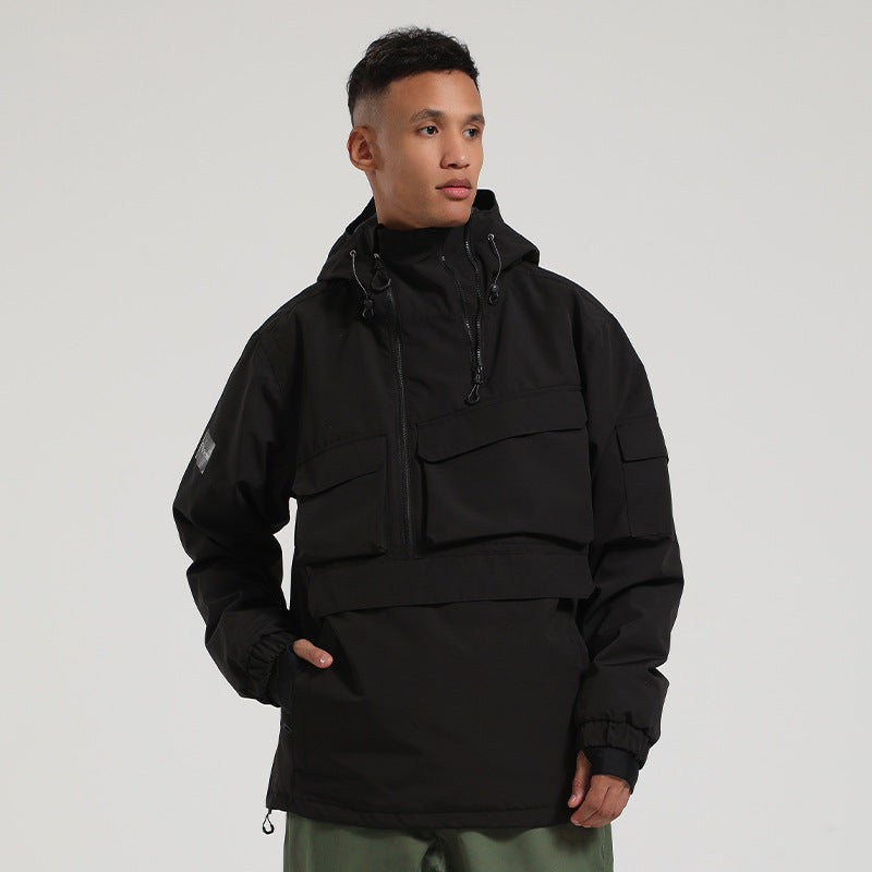 Model wearing the black Range pullover snow jacket, showing its high collar and large front pockets.