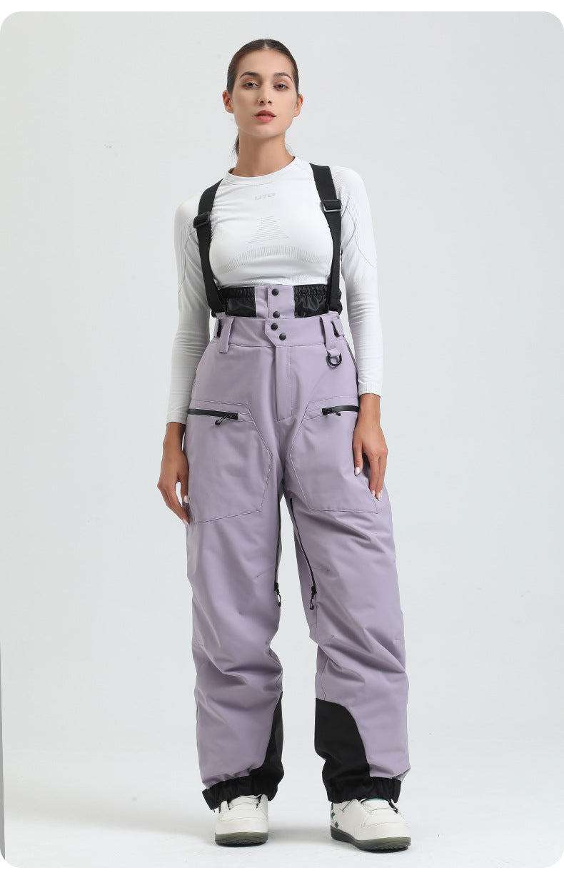 Women's lavender insulated suspender snow pants, angled model-worn view